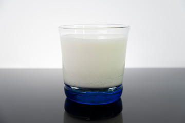 Dairy white milk in the glass isolated on black background