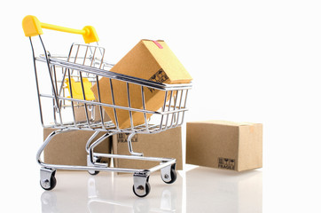 Paper boxes in a trolley on white background. Ideas online shopping is a form of electronic...