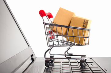 Many boxes in a trolley on a white background. Ideas online shopping is a form of electronic...