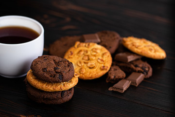 cookies and cup of coffee on dark wooden background