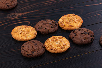 Chocolate cookies on wooden table. Homemade food on wooden background