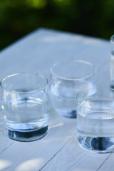 clear fresh water in transparent glasses on wooden table