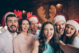 Self-portrait of nice attractive lovely winsome cheerful comic glad childish positive ladies gentlemen having fun showing tongue out lick lips wink blink costume industrial loft interior room indoors