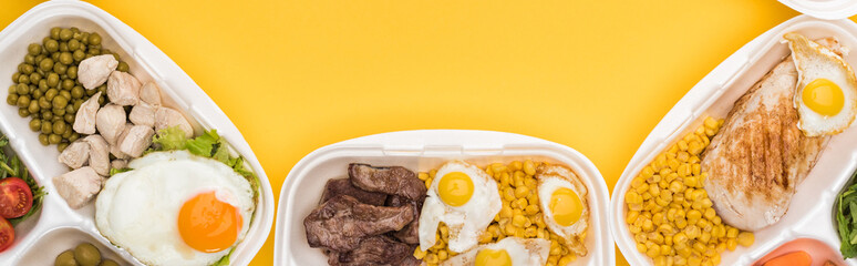 panoramic shot of eco packages with vegetables, meat, fried eggs isolated on yellow
