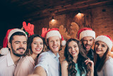 Self-portrait of nice attractive lovely cheerful comic childish glad positive ladies gentlemen having fun showing tongue out wink blink costume in industrial loft interior room indoors