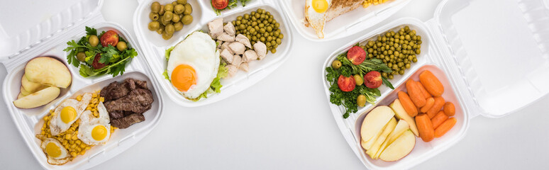 panoramic shot of eco packages with apples, vegetables, meat, fried eggs and salads on white background