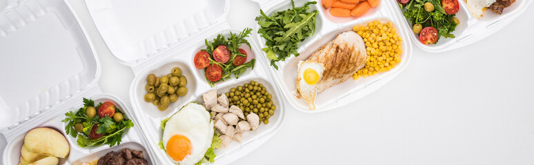panoramic shot of eco packages with apples, vegetables, meat, fried eggs and salads on white background