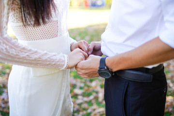 Bride and groom holding hands outdoors