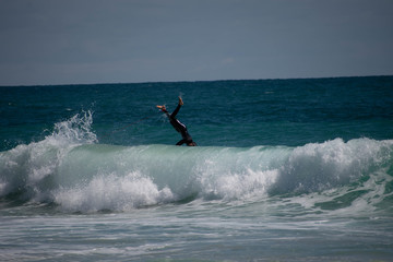 Person leaping over a wave