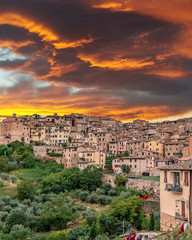 Sunset over colorful buildings in Siena Italy