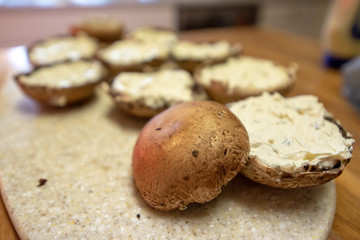 making of portobello mushrooms stuffed with cheese and sprinkled with pine nuts
