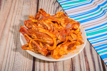 Lamb ribs marinated with spices in a plate on the table.