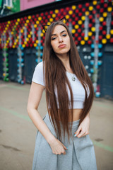 Naklejka premium very cute young girl posing as top models on a street in Europe on vacation,actively posing on a sunny summer day,very happy and joyful 