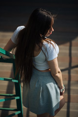 very cute young girl posing as top models on a street in Europe on vacation,actively posing on a sunny summer day,very happy and joyful 