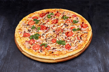 Fresh pizza with BBQ sauce on wooden cutting board. isolated on dark background.