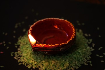 Happy Diwali background - Colorful Clay Diya lit during Deepavali festival, selective focus
