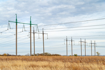 High voltage power line. Supports high-voltage lines, cloudy landscape in cloudy weather.