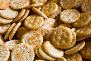 Close up on bunch of round crackers. Popular crunchy snack background.