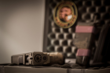 A closeup of a Tan gun in a case lined with foam.