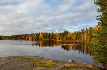 Autumnal scenery at the lake shore in Finland. October day with cloudy sky.