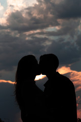 couple kissing at sunset