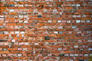 Old brick wall. Multi-colored brickwork with wide concrete seams in the loft style.