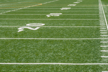 looking down sideline of football field from endzone