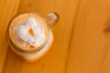 Thai milk tea smoothie in giant glass.