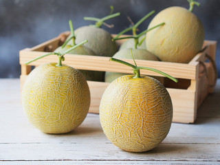 Honeydew or melon fruit on wooden table.