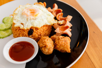 American fried rice in Thai fast menu, topping with egg, sausage and Chicken nuggets.