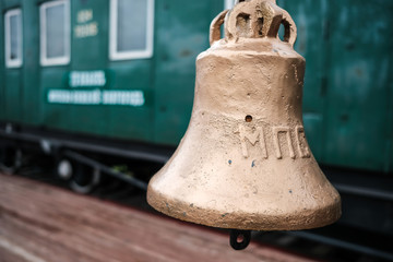 Fototapeta premium Gold bell at railway station in Moscow, The bell is used to tell the signal to release the train, Vintage Russian train background.