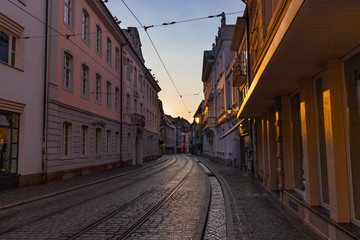 Street of the city center of freiburg, germany, in sunset