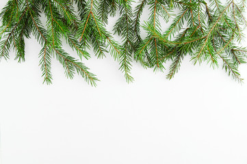 Obraz premium Christmas tree branches close-up on a white background. View from above.