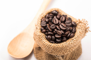 Obraz premium Coffee beans in sack on white background