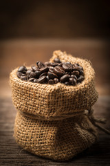 Coffee beans in sack on wood table