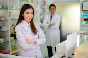 woman and man pharmacist are stand by in charge in pharmacy drug store
