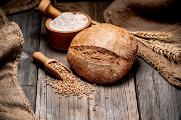 Freshly baked traditional bread on wooden table