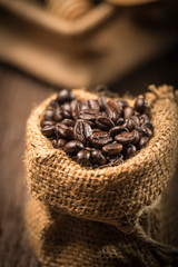 Coffee beans in sack on wood table