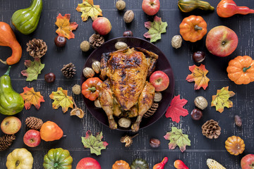 Roasted chicken between vegetables and fruits