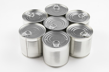 Group of silver canned food on white background.