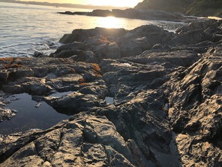 rocks in sea at sunset