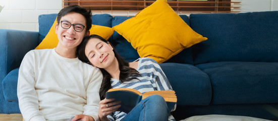 sweet lovey asian family couple sit talk good conversation on sofa in living room house background
