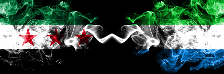 Syrian Arab Republic vs Sierra Leone smoke flags placed side by side. Thick colored silky smoke flags of Syria opposition and Sierra Leone