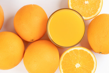 Fresh orange juice in glass on white yellow background