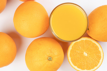 Fresh orange juice in glass on white yellow background