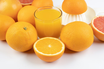 Fresh orange juice in glass on white yellow background