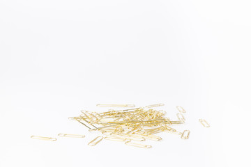 Gold paperclips isolated on a white background