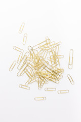 Gold paperclips isolated on a white background