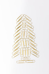 Christmas tree from Gold paperclips isolated on a white background.