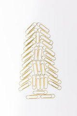 Christmas tree from Gold paperclips isolated on a white background.